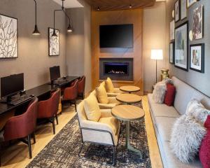 a living room with a couch and a fireplace at Hyatt Place Harrisonburg in Harrisonburg