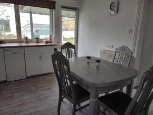 a kitchen with a table and chairs with two cups on it at Ferienwohnung am Rittergut in Grebenstein