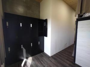 a room with black lockers on the wall at Hey Castle B&B in Xiaoliuqiu