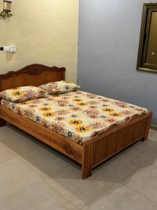 a bed in a bedroom with a floral mattress at Prestige House in Ouagadougou
