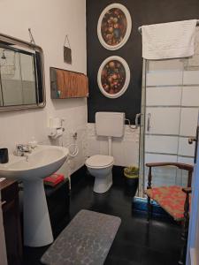 a bathroom with a white sink and a toilet at B&B LaMaGia di Corte Moronati in Sirmione