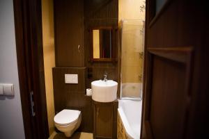 a small bathroom with a toilet and a sink at Apartament Rynek 10 in Ostrowiec Świętokrzyski