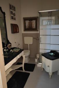 a bathroom with a sink and a toilet and a shower at B&B LaMaGia di Corte Moronati in Sirmione