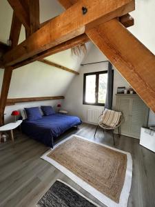 a bedroom with a bed and a large window at Cottage Guerande in Guérande
