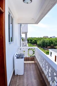 a balcony with a trash can on a white railing at Siloam Apartments in Mombasa