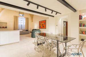 a kitchen and living room with a glass table and chairs at Zema Home by Apulia Accommodation in Bari