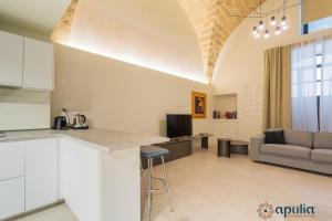 a kitchen and living room with a couch and a table at Zema Home by Apulia Accommodation in Bari