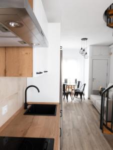 a kitchen and living room with a sink and a couch at VUT Adarve in Avila