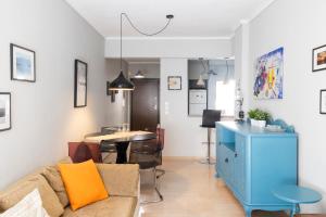 a living room with a couch and a table at Four Reasons Apts Ntepo in Thessaloniki