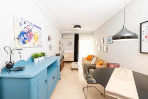 a living room with a blue cabinet and a couch at Four Reasons Apts Ntepo in Thessaloniki