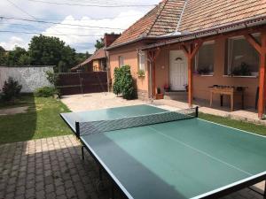 a ping pong table in the backyard of a house at Bükk-Völgye Vendégház in Bogács