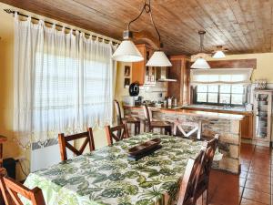 a dining room with a table and a kitchen at ThatsHome Villa Pedriñas in Sanxenxo