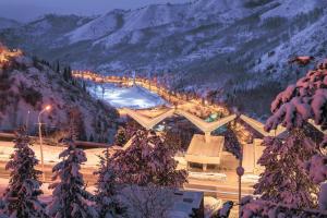 a resort in the mountains with snow on the ground at Nadezhda Apartments in Samal in Almaty