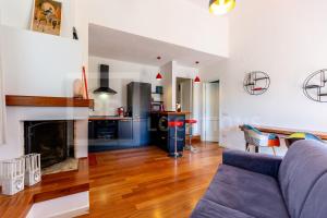 - un salon avec un canapé et une cheminée dans l'établissement Appartamento Baia Azzurra - BeLocations, à Capitana