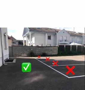 a parking lot with x signs in front of a house at Appartement des 3 pays. 2 mn de Bâle+ Free parking in Saint-Louis