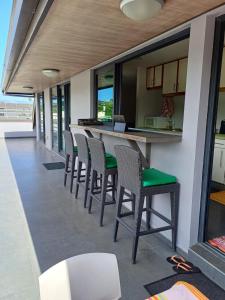 an outdoor bar with chairs and a counter at roof top Papeete in Papeete