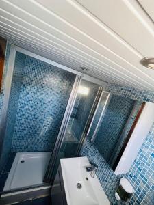 a bathroom with a tub and a sink and blue tiles at Lusaas Yacht in Kas