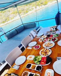 a table with plates of food on top of a boat at Lusaas Yacht in Kas