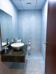 a bathroom with a sink and a toilet at Dubai Town Jumeirah Beach Residence in Dubai