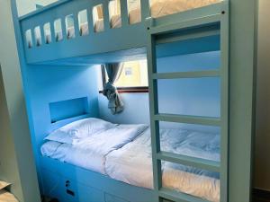 a bunk bed with a ladder in a bedroom at Dubai Town Jumeirah Beach Residence in Dubai
