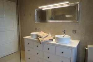 a bathroom with two sinks and a mirror at Molibeau in Beauvais