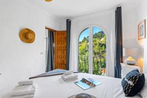 a bedroom with a bed and a window with a balcony at Villa Domingo - PlusHolidays in Benissa +49 photos