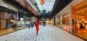 a person standing in the middle of a shopping mall at City break Park Studio Bucharest in Bucharest