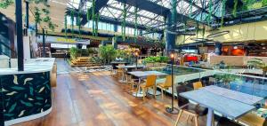 a restaurant with tables and chairs in a building at City break Park Studio Bucharest in Bucharest