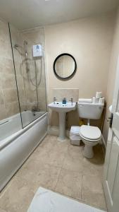 a bathroom with a toilet and a sink and a shower at City Gem - Central & Stylish 1 Bed Apartment in Dublin