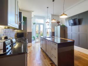 a kitchen with black counter tops and a stove top oven at Belmont House in Broadstairs