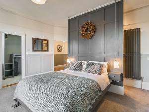 a bedroom with a large bed with a black headboard at Belmont House in Broadstairs