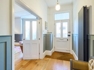 a hallway with a white door and a kitchen at Belmont House in Broadstairs