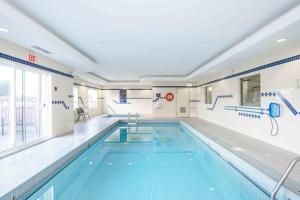 a large indoor swimming pool with a large swimming pool at Sandman Hotel Quesnel in Quesnel