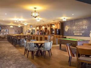 a restaurant with tables and chairs and a pool table at Meres Retreat in Saxmundham