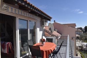 a patio with a table and chairs on a balcony at Apartman Marko in Tribunj