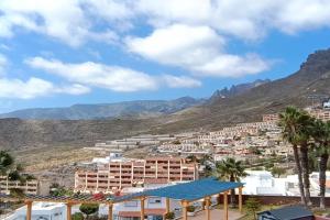 a view of a city with mountains in the background at Balcon Roque del Conde in Adeje