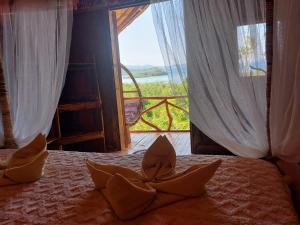 a bedroom with a bed with a view of a window at Jungle Bar Honeymoon suite & private pool in San Vicente