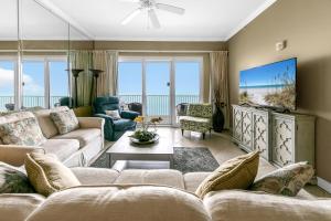 a living room with a couch and a tv at Grandview East 1503 in Panama City Beach
