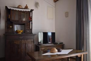 a living room with a table and a tv at Apartman Marko in Tribunj