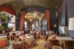 a restaurant with tables and chairs in a room at Rigat Park & Spa Hotel - Adults Recommended in Lloret de Mar
