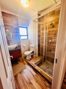 a bathroom with a toilet and a glass shower at Morningside41 in Ongwediva