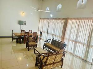 a room with chairs and a table and a dining room at Wimbledon Two Rooms Apartment in Colombo