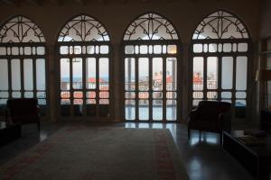 
a living room filled with furniture and a window at The Efendi Hotel Akko in Acre
