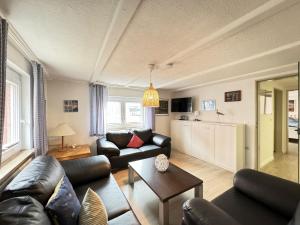 a living room with a couch and a table at Führs in Borkum
