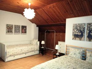 a bedroom with two beds and a wooden ceiling at Nest 4 Rest in Konstancin-Jeziorna