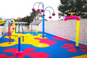 an empty playground with a colorful play area at CHEZ LOLO MH 3CH 2SDB CLIM 8p VUE CHAMPS EMPLACEMENT CALME in Onzain