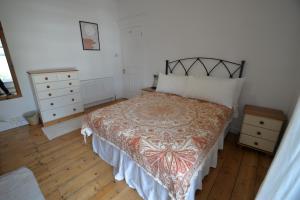 een slaapkamer met een bed en een dressoir bij Bright and cosy, central 3 bedroom home in Plymouth