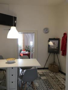 a living room with a white table and chairs at Medieval terraced house in Vieste Vecchia in Vieste