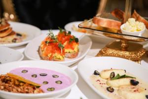 a group of plates of food on a table at Royal Palace Luxury Hotel and SPA in Khmelʼnytsʼkyy