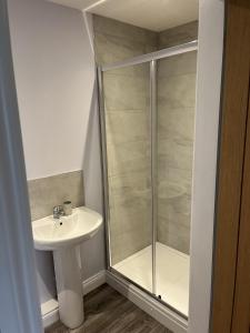 a bathroom with a sink and a shower at Fleetwood 2 bed cottage in Tunstall